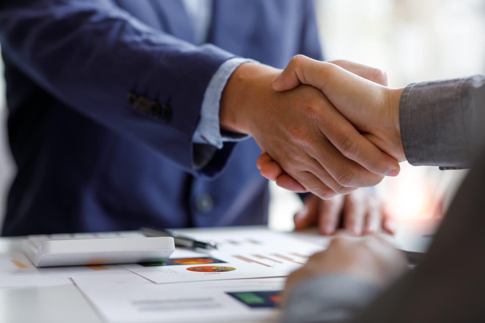 Two professionals shaking hands, representing a Shreegopal Polychem customer partnership
